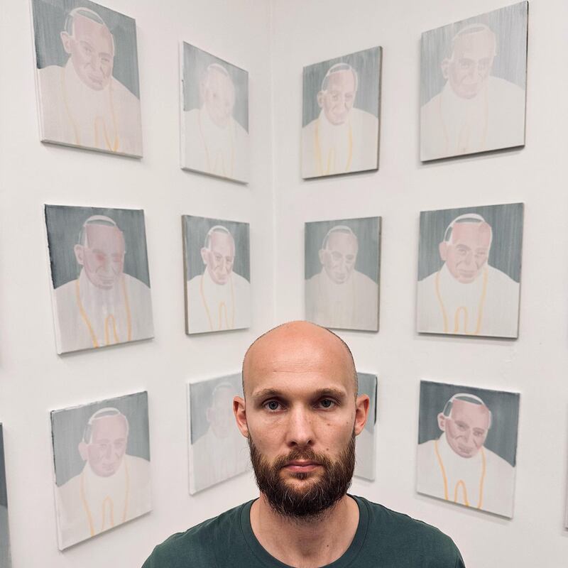 Polish artist Bartek Kielbowicz at his Warsaw exhibition of Pope John Paul II portraits. Photograph: Piotr Oklowski