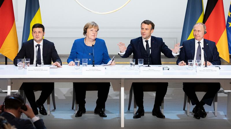 Emmanuel Macron, France’s president, second right, speaks as Volodymyr Zelenskiy, Ukraine’s president, left, Angela Merkel, Germany’s chancellor, second left, and Vladimir Putin, Russia’s president, right, listen during a news conference following a  summit on Ukraine at Elysee Palace in Paris, France, on Monday. Photograph: Bloomberg