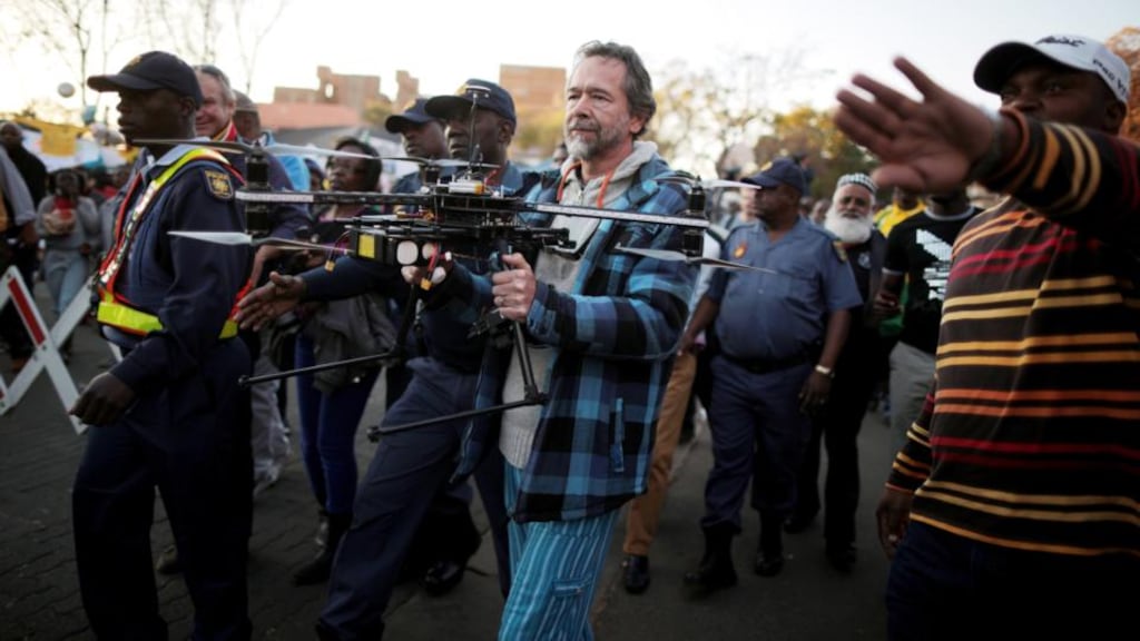 Police detain a man carrying a remote aerial camera that flew over crowds outside the hospital where Nelson Mandela is being treated. Photograph: Christopher Furlong/Getty Images