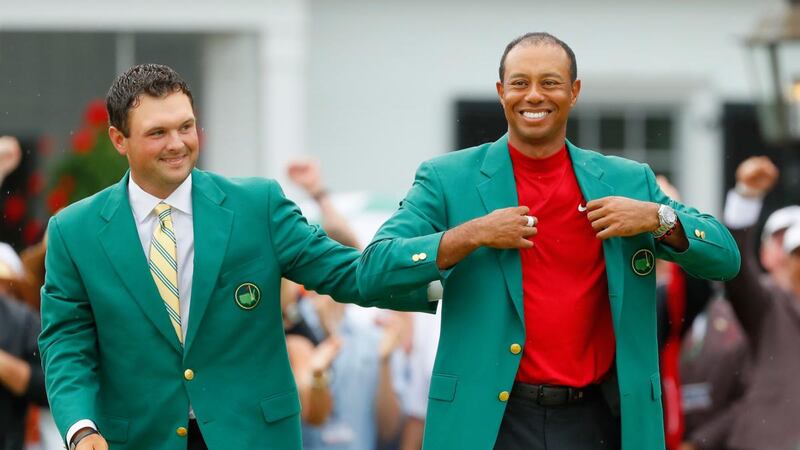 Tiger Woods is awarded the Green Jacket by Masters champion Patrick Reed  after winning the Masters at Augusta National Golf Club on Sunday. Photograph: Kevin C Cox/Getty Images