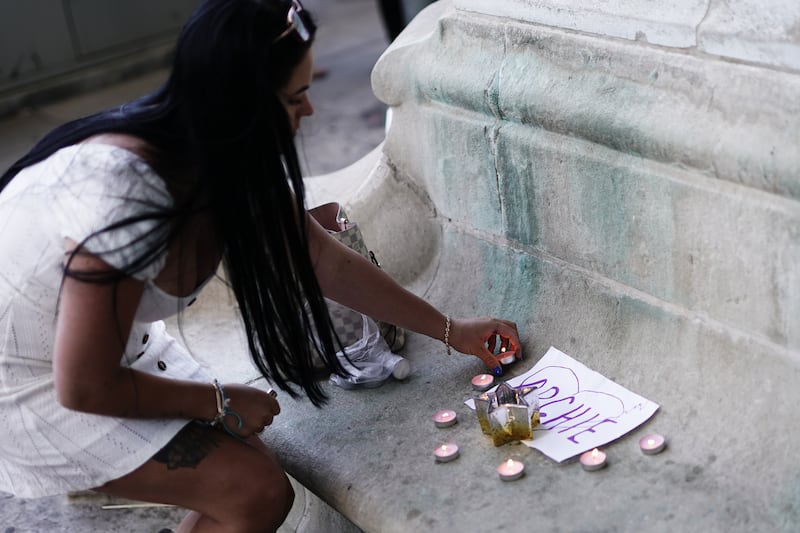 A person lights candles outside the Royal London hospital in Whitechapel, east London, following the death of Archie Battersbee. Photograph: Aaron Chown/PA