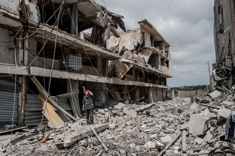 A resident walks among the damage in the aftermath of an Israeli air strike in Tyre, Lebanon, on Tuesday. Photograph: Daniel Berehulak/The New York Times
                      