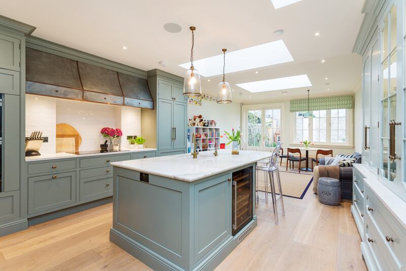 The classic in-frame design by Wooddale Designs includes deep drawers and marble-look worktops