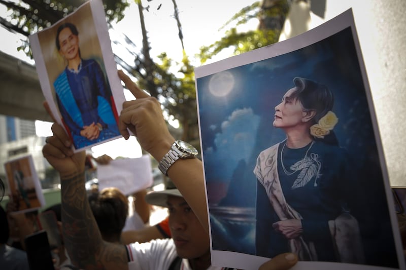 Myanmar migrant workers living in Thailand hold pictures of Aung San Suu Kyi at a rally outside the Myanmar embassy in Bangkok earlier this month. Photograph: EPA