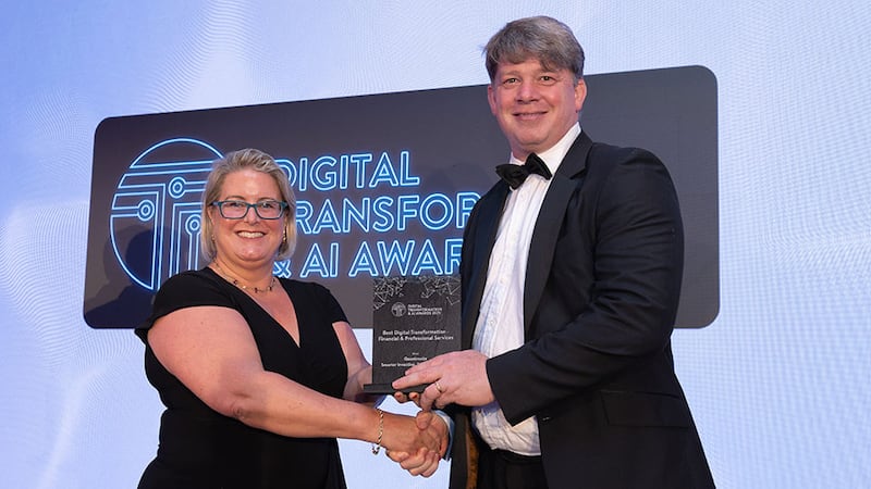Maria Svejdar, award judging coordinator, presents the best digital transformation - financial & professional services to Joe Shine, Quantmatix
