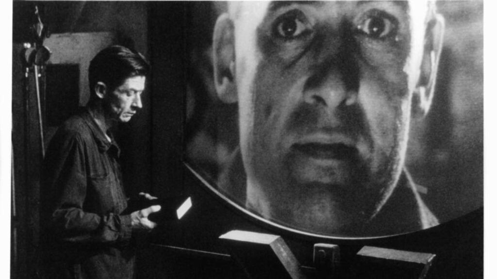John Hurt holds a book in a scene from the film, 1984. Photograph: Atlantic Releasing Corporation/Getty Images