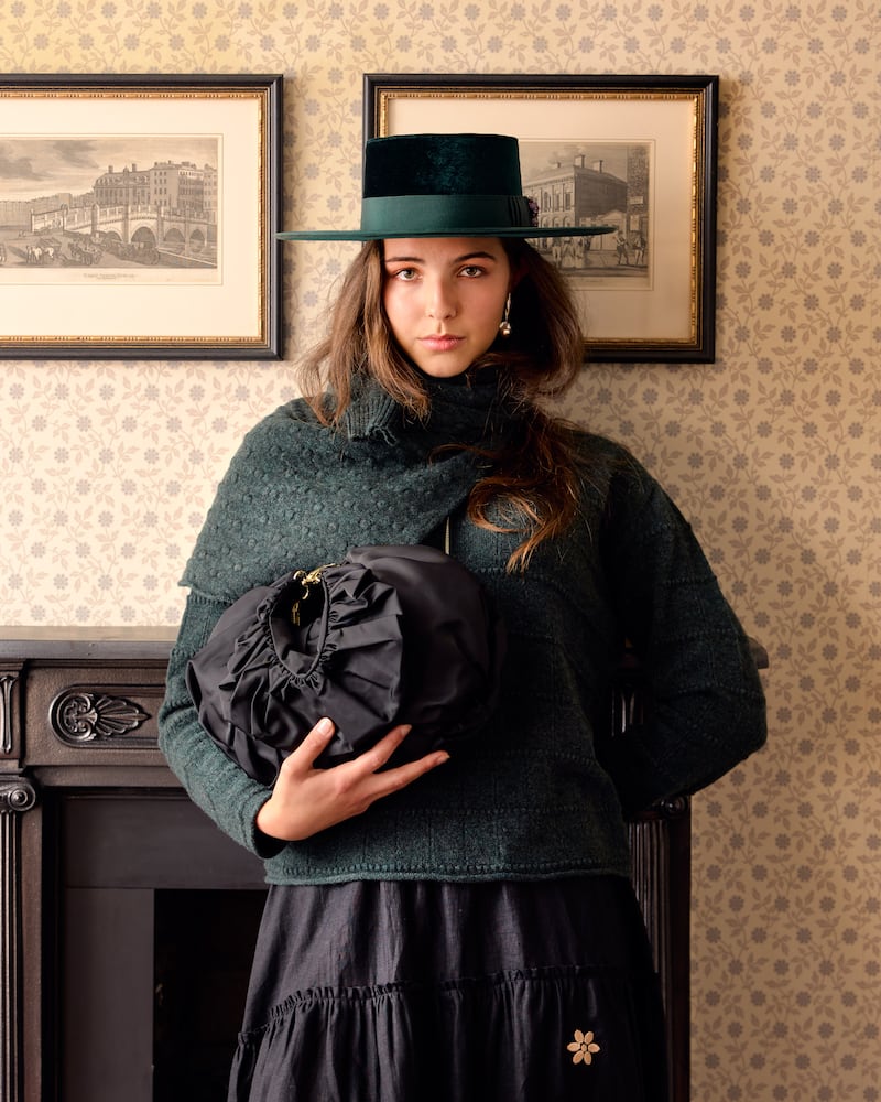 Green velvet boater, €420, FAO Millinery; polka sweater and pine turtleneck, €640 and €685, both Ros Duke; embroidered skirt, €290, Jennifer Slattery; and mini ruche hobo black taffeta, €275, August Night
