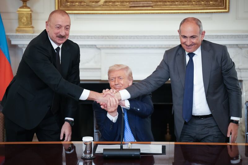 US president Donald Trump (C) joins hands with Azerbaijani president Ilham Aliyev (L) and Armenian prime minister Nikol Pashinyan (R) during an agreement-signing ceremony at the White House on August 8th, 2025. Photograph: Andrew Harnik/Getty Images
