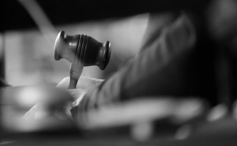 Rody Keighery holds his gavel as he conducts the ceremonies