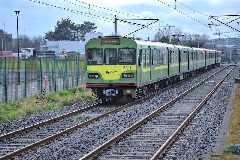 Dublin, Ireland - March 14, 2021: Beautiful distant view of entire DART train in action at Blackrock train station