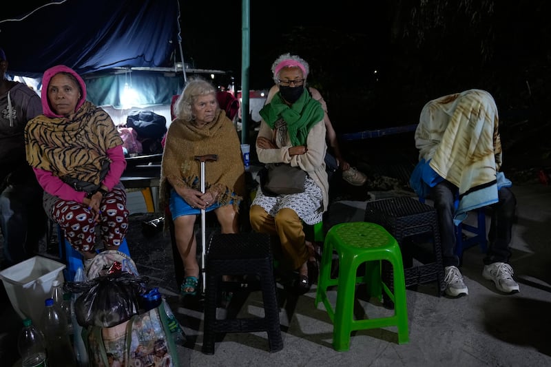 People outside their homes following the earthquake. Photograph: Ariana Cubillos/AP