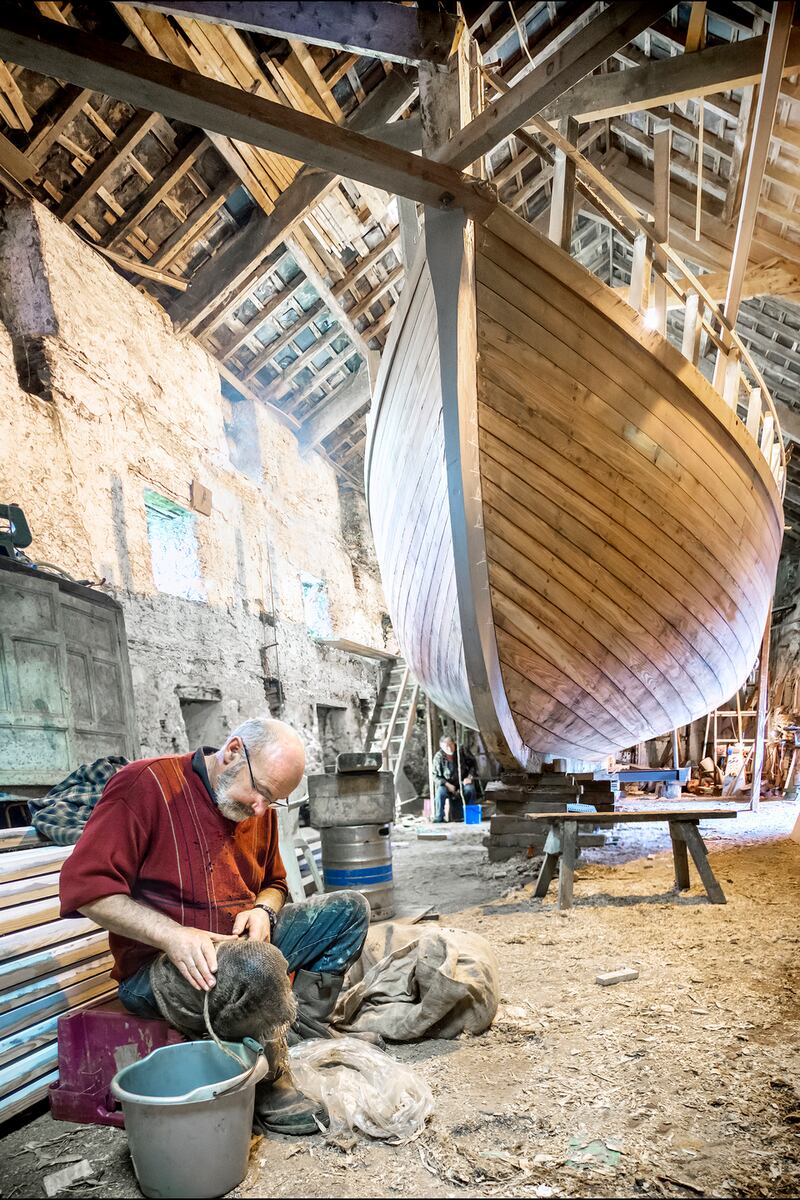 Teddy O’Donovan handrolling oakum for the plank seams