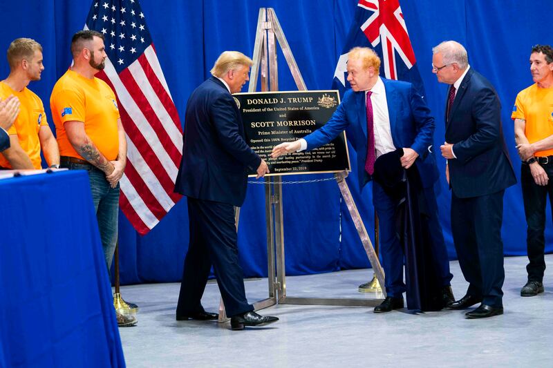 Former US president Donald Trump shakes hands with Anthony Pratt, the owner of Pratt Industries, as former  Australian prime minister Scott Morrison looks on, during a tour of a Pratt Industries plant in Ohio in 2019.  Photograph: Doug Mills/New York Times
                      