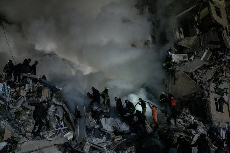Civilians and emergency responders at 118 Victory Embankment, an apartment complex in Dnipro, Ukraine, where a Russian Kh-22 missile strike killed at least 46 people on Saturday. Photograph: Nicole Tung/The New York Times