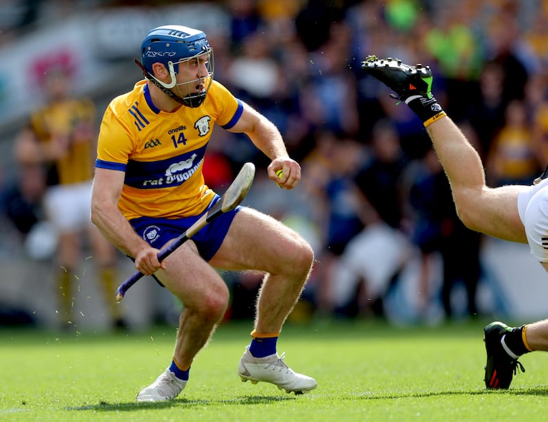 Shane O'Donnell goes past Kilkenny's Tommy Walsh before scoring Clare's goal. Photograph: James Crombie/Inpho