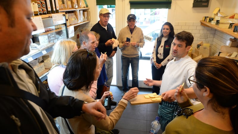 The group samples some cheeses from Sheridan’s Cheesemongers, served up by Michael Conefrey.  Photograph: Dara Mac Dónaill