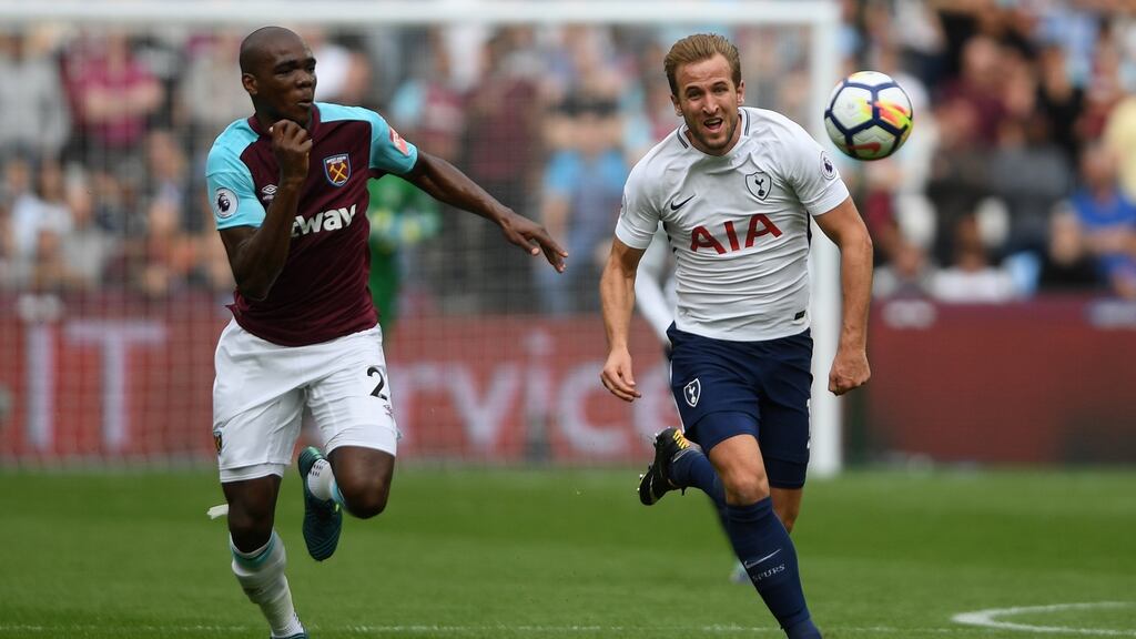 Harry Kane is chased by Angelo Ogbonna of West Ham. Photograph: Mike Hewitt/Getty Images