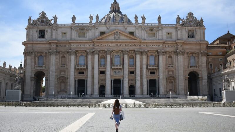 Visiting the Vatican: St. Peter’s Square in the Vatican, usually packed, is surprisingly quiet in this photo. Charlotte Waldron pictured walking towards St Peters Basilica, in the sunshine in late May