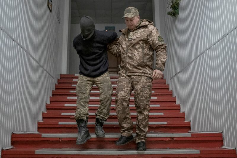 A captured Wagner fighter loyal to Russian forces is escorted by a Ukrainian guard at a prison in Dnipro in April.  Photograph: Mauricio Lima/New York Times
                      