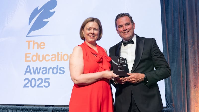 Paula Hodson, awards judge, presents the best library team to Shane Mooney, Dublin Business School
