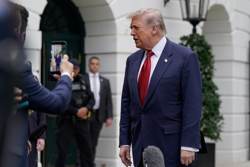 US president Donald Trump speaks to the media outside the White House on Sunday. Photograph: Jose Luis Magana/AP