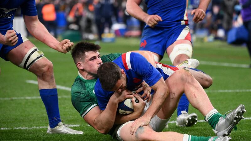 Ireland hooker Dan Sheehan holds up France fullback Melvyn Jaminet to prevent a try being scored during the game at Stade de France. Photograph:  Franck Fife/AFP via Getty Images
