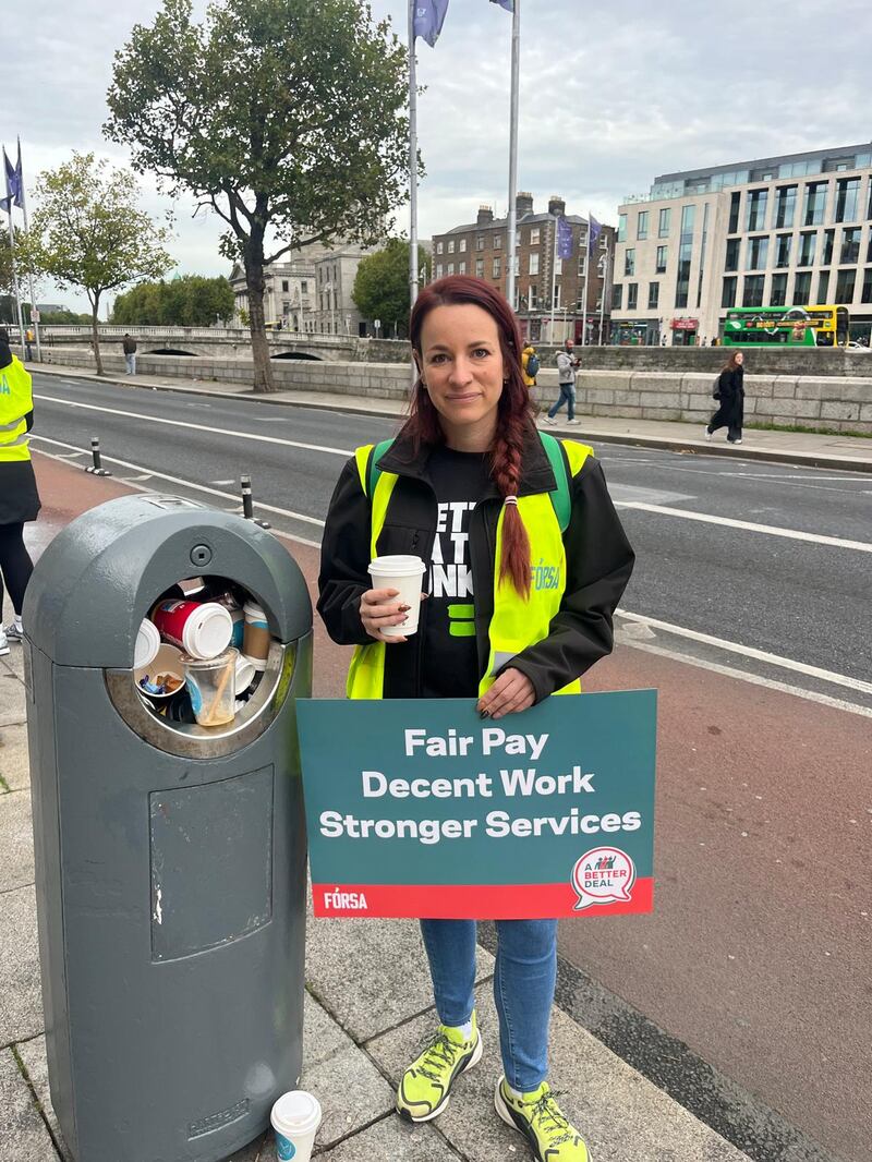 Audrey Lambert, Dublin City Council staff officer and Forsa Dublin city branch secretary, stands beside an overflowing bin outside the Civic offices. Photograph: Olivia Kelly