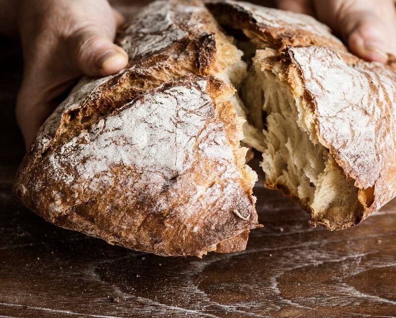 Tearing a bread loaf photography recipe idea. Photograph: iStock