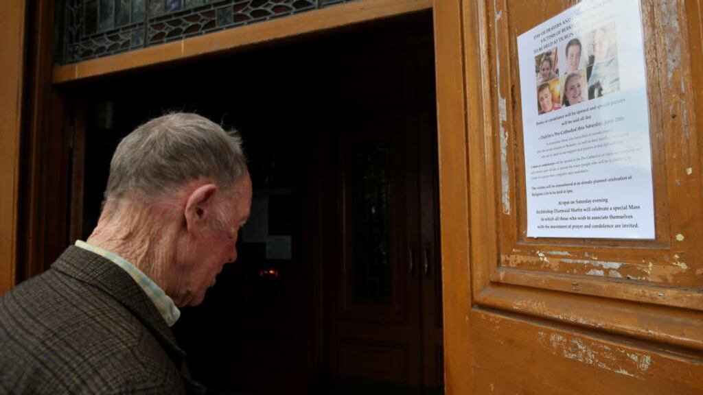A member of the public arrives to sign a book of condolence at the Pro Cathedral in Dublin’s city centre for those killed in the Berkeley balcony collapse. Photograph: Brian Lawless/PA Wire