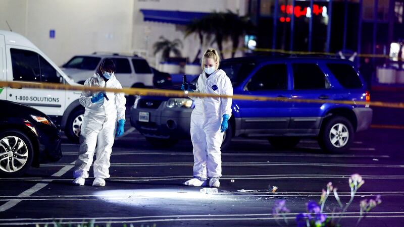 Police officers investigate the  shooting at the Gable House Bowl. Photograph: Reuters