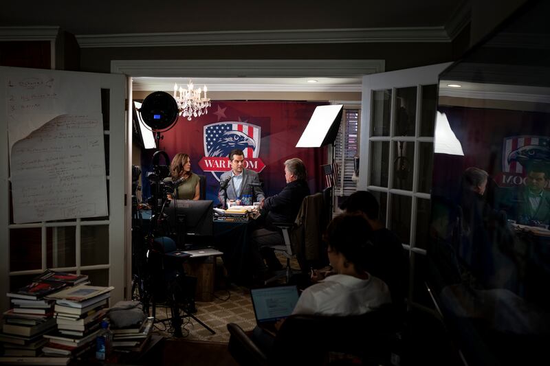 Republicans Nancy Mace and Matt Gaetz with Steve Bannon in his basement studio. Photograph: Erin Schaff/New York Times
                      