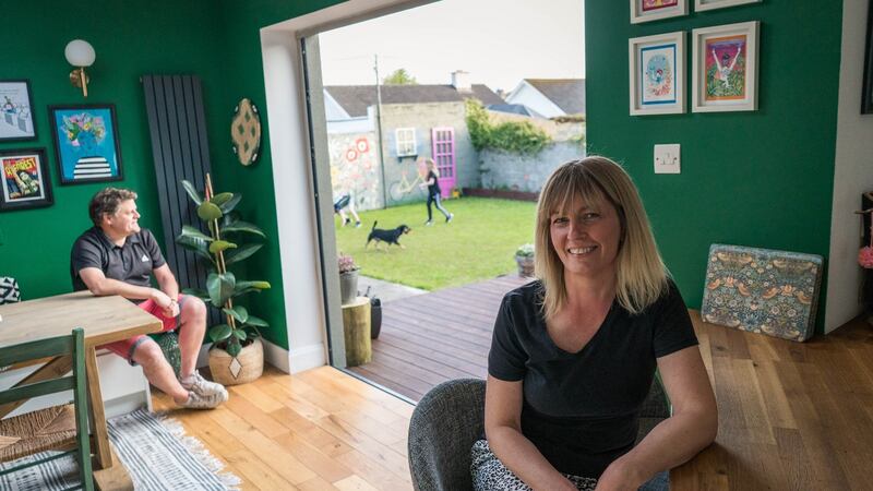 Karen Cafferkey and  Joe Hurl  replaced a window with a bi-folding door leading onto a huge deck that Joe built.  Photograph: Keith Heneghan