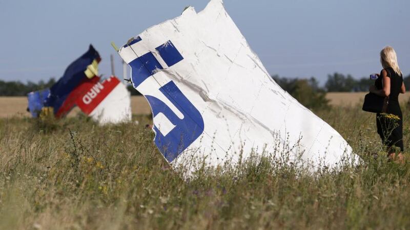 A woman takes a photograph of wreckage at the crash site of Malaysia Airlines Flight MH17 near the village of Hrabove (Grabovo), Donetsk region. Photograph: Reuters