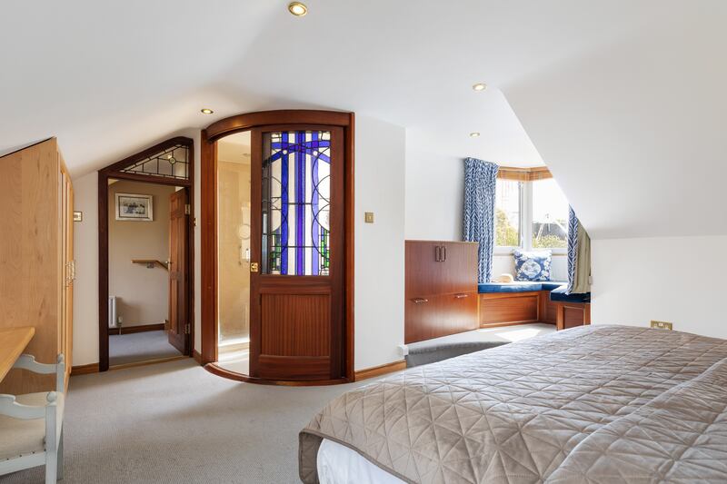 Dormer bay window seat and stained-glass door to en suite