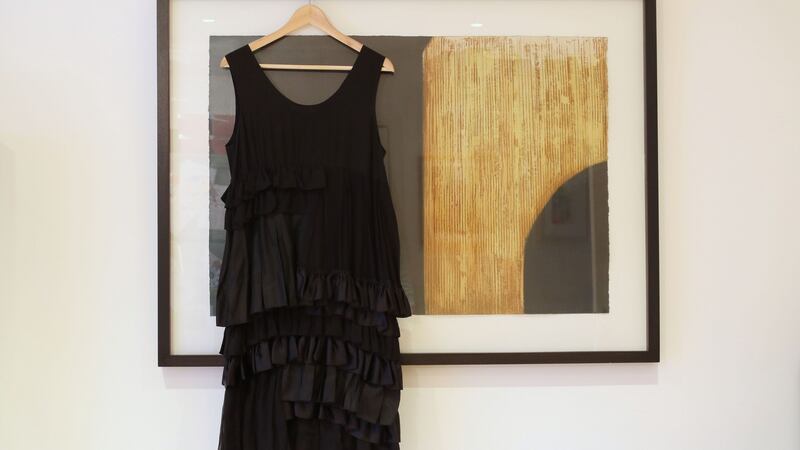 Angela O’Kelly’s  wedding dress by John Rocha, hanging from her Stephen Vaughan print in the kitchen. Photograph: Nick Bradshaw