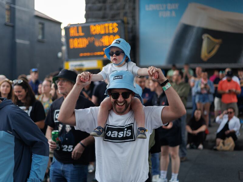 Setanta Sé Ó Broin and dad Stiofán Ó Broin from Drumcondra, Dublin 9, listen to Oasis on the streets around Croke Park. Photograph: Dan Dennison