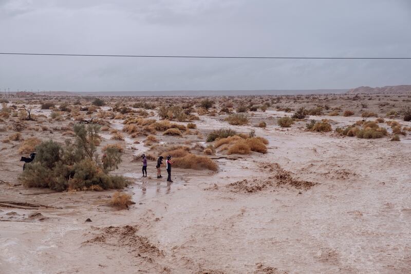 Mud and water run down from the mountains in the desert near Salton City, California, as Tropical Storm Hilary lashed southern California. Photograph: Mark Abramson/The New York Times
                      