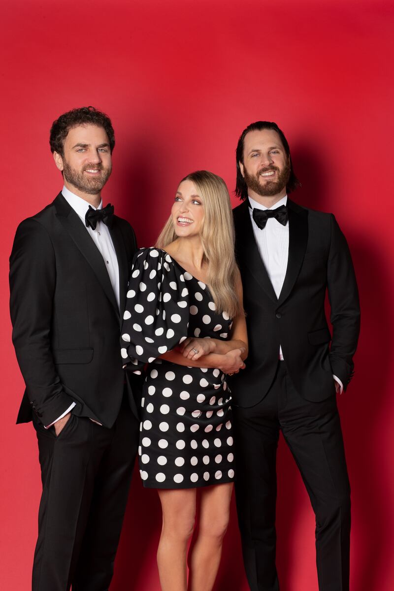Amy, one shoulder polka dot dress, Pinko, Harvey Nichols,€455;
shoes; ring, Goossens, Weir & Sons,€280; earrings, Amy Huberman Newbridge Silverware collection, €40. Mark (right) tuxedo, Carl Gross €495; Shirt, Remus Uomo, €85; bow tie, Next, €21; shoes, Best Menswear, €119.95. Paul, tuxedo, Carl Gross, €495; shirt, Remus Uomo, €69.95; bow tie, Next, €21; shoes, Best Menswear €119.95. Styling by Megan Fox, photos by Emily Quinn