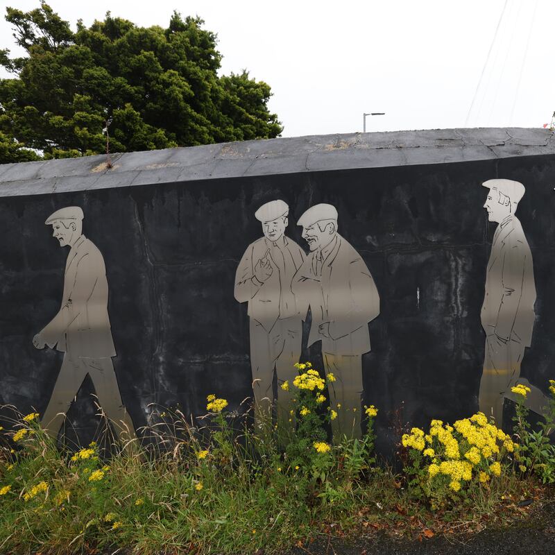 A large artwork in Seapatrick shows workers on their way to what was once the linen mill in the village. Photograph: Bryan O’Brien