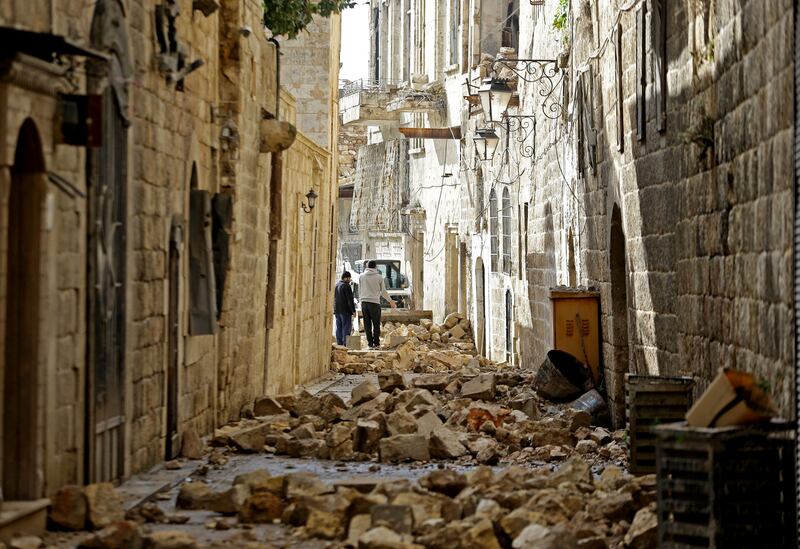 People walk among the rubble in Aleppo's old town, Syria. Photograph: Louai Beshara/AFP via Getty Images