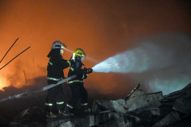 Firefighters battle to put out the fire. Photograph: Chen Sihan/Xinhua via AP