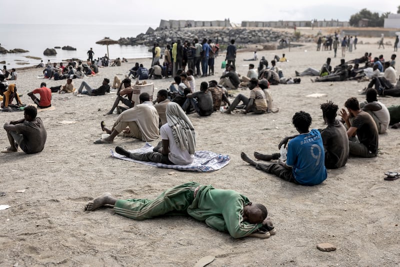 Migrants wait for humanitarian assistance on a beach in Ceuta on August 1st. Photograph: Finbarr O'Reilly/The New York Times