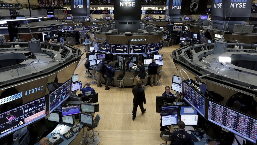 Traders work on the floor of the New York Stock Exchange on Friday Photograph: Reuters
