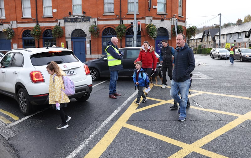Parents and children cross at a busy intersection in Chapelizod village. Photograph: Bryan O’Brien/The Irish Times
