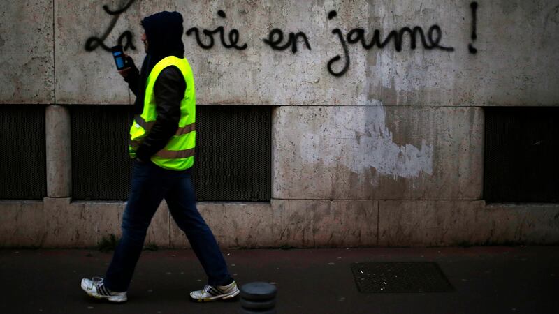 Graffiti on a wall that reads “life in yellow” during a demonstration in Rouen, northwestern France. Photograph:  Charly Triballeau/AFP/Getty Images