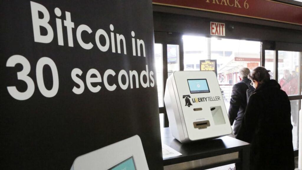 Commuters walk past a Bitcoin ATM in Boston, Massachusetts. Bitcoin, the digital money based on a peer-to-peer software protocol, has no central issuing authority. Photo: Bloomberg