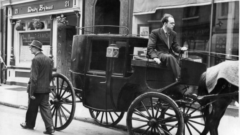 Patrick Kavanagh after disembarking from the horse-drawn carriage after his pilgrimage to Sandymount Strand for Bloomsday in 1954 in South Anne Street, Dublin. Anthony Cronin was the coachman for the pilgrimage. Photograph: Dermot Barry