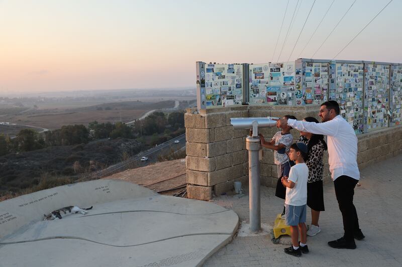 People on Kobi Hill in Sderot, on the Israeli side of the border with Gaza, watch an Israeli airstrike being carried out near Beit Hanoun. Photograph: Abir Sultan/EPA