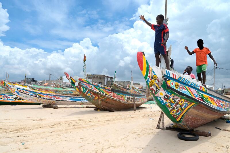 Young boys play on a pirogue in Fass Boye in August. Photograph: Seyllou/AFP via Getty Images