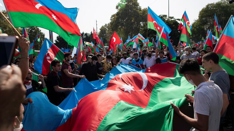 Protesters hold up a huge Azerbaijan flag as they shout slogans in a demonstration  supporting Azerbaijan against Armenia, in Istanbul, Turkey, on Sunday. Photograph: Tolga Bozoglu/EPA